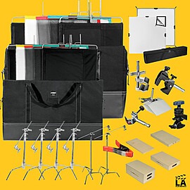 Full photography studio kit with bags, light stands, clamps, backdrops, and accessories on a yellow backdrop.